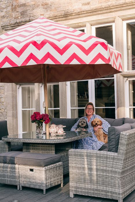 Tara the Celebrant on a garden patio with her dog